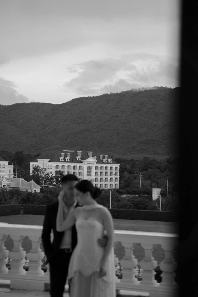 Mauric and Nadya on a balcony in a softly focused black-and-white photograph