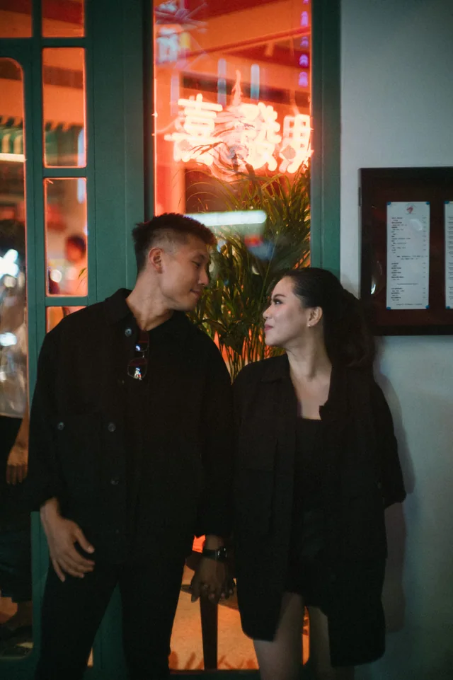 Mauric and Nadya gazing at each other under the evening lights