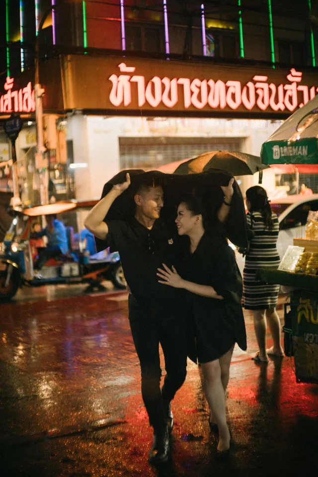 Mauric and Nadya holding hands on a street at night